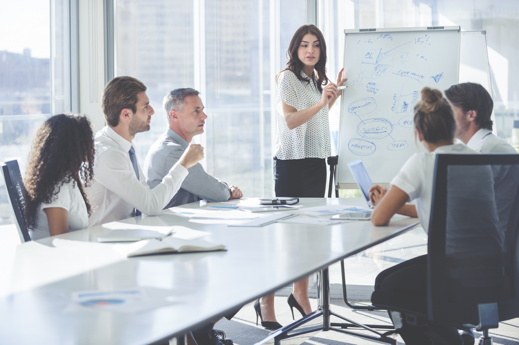 Woman giving a presentation to her team.